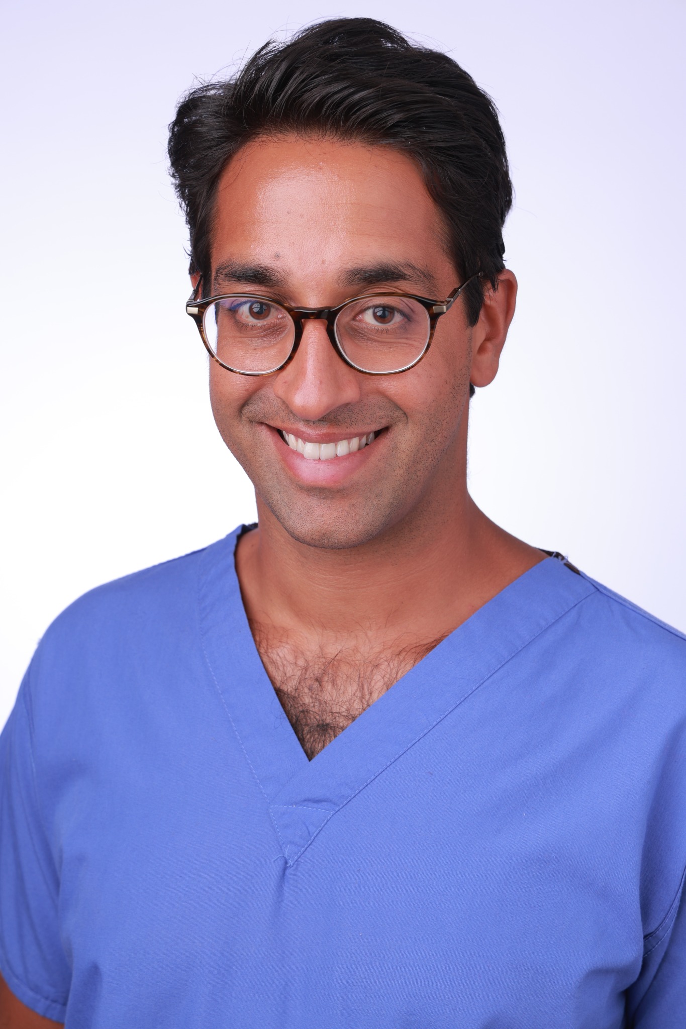 Dr Anish Bhuva in clinical scrubs